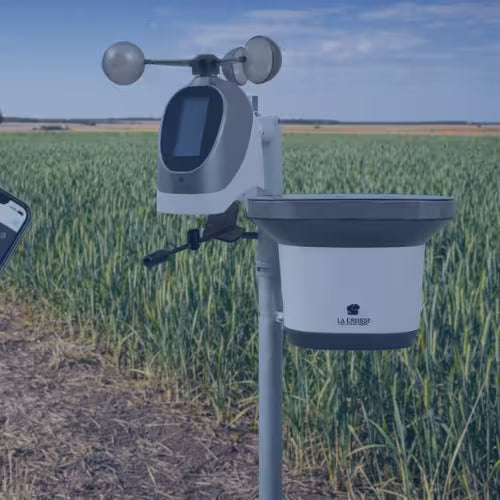 Weather station in a field with a clear sky